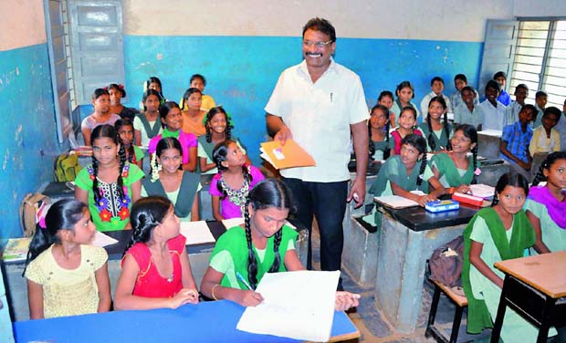 Headmaster M. Vijaya Prakash Rao with his students. Headmaster M. Vijaya Prakash Rao with his students.